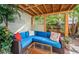 Relaxing covered patio with wicker furniture and tropical plants at 302 Lagoon Dr, Palm Harbor, FL 34683