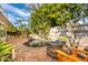 Inviting pool area with brick patio, fire pit, and lush landscaping at 351 Barbara Cir, Belleair, FL 33756