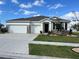 Beautiful two-car garage home with landscaping at 1027 Ocean Spray Dr, Ruskin, FL 33570