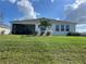 Backyard view with covered patio at 1027 Ocean Spray Dr, Ruskin, FL 33570