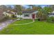 Single-story house with red door and storm damage at 108 85Th N Ave, St Petersburg, FL 33702