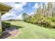 Serene backyard view with grassy area and tranquil waterway at 2104 Hembury Pl # 33, Sun City Center, FL 33573
