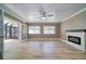 Spacious living room with light flooring, fireplace, and access to a sunroom at 1807 Sunrise Blvd, Clearwater, FL 33760