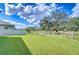 Backyard with a large tree and a privacy fence at 10330 Stallion Fields Way, Tampa, FL 33647