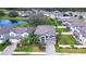 An aerial view of a house and neighborhood with a lake nearby at 10330 Stallion Fields Way, Tampa, FL 33647