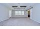 Spacious bedroom with high ceilings, large windows, and private balcony access at 10330 Stallion Fields Way, Tampa, FL 33647