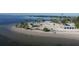 Scenic aerial view of a sandy beach with picnic pavilions and clear turquoise waters at 2571 Cyprus Dr # 1-202, Palm Harbor, FL 34684