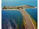 Stunning aerial view of a causeway leading to a tropical island with sandy beaches and lush trees at 2571 Cyprus Dr # 1-202, Palm Harbor, FL 34684
