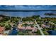 Aerial view of a community with a lake, pool, and boat docks at 2571 Cyprus Dr # 1-202, Palm Harbor, FL 34684