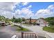 Aerial view showcasing a parking lot and the house with a charming curb appeal at 2571 Cyprus Dr # 1-202, Palm Harbor, FL 34684