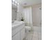 Bathroom featuring white vanity, toilet, shower and tub combination at 2571 Cyprus Dr # 1-202, Palm Harbor, FL 34684