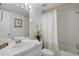 Bright bathroom with white fixtures, a shower-tub combo, and tasteful decor providing a clean and functional space at 2571 Cyprus Dr # 1-202, Palm Harbor, FL 34684