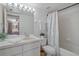 Well-lit bathroom featuring a vanity with ample counter space, a shower-tub combo, and neutral decor for a clean and modern feel at 2571 Cyprus Dr # 1-202, Palm Harbor, FL 34684