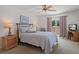 Inviting bedroom with a cozy bed, ceiling fan, and sliding glass doors that open to a patio at 2571 Cyprus Dr # 1-202, Palm Harbor, FL 34684