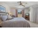 Cozy bedroom featuring a comfortable bed, ceiling fan, and a sliding glass door leading to the patio at 2571 Cyprus Dr # 1-202, Palm Harbor, FL 34684