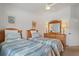 Bright bedroom with two twin beds, wooden furniture, and ceiling fan at 2571 Cyprus Dr # 1-202, Palm Harbor, FL 34684