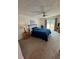 Bright bedroom featuring a comfy bed and access to a balcony at 2571 Cyprus Dr # 1-202, Palm Harbor, FL 34684