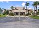 Exterior of a two-story condominium building with stairs and covered patios at 2571 Cyprus Dr # 1-202, Palm Harbor, FL 34684