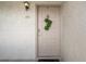 Beige front door with wreath and unit number 202 at 2571 Cyprus Dr # 1-202, Palm Harbor, FL 34684