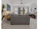 Living room with tile floors, neutral-toned furniture, and sliding glass doors at 2571 Cyprus Dr # 1-202, Palm Harbor, FL 34684