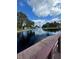 Serene canal view with lush vegetation and waterfront homes at 2571 Cyprus Dr # 1-202, Palm Harbor, FL 34684