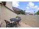 Cozy outdoor patio with a round table, seating for two, and scenic views of the neighborhood and landscape at 2571 Cyprus Dr # 1-202, Palm Harbor, FL 34684