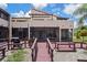 This property features a charming rear exterior and an expansive wooden deck, perfect for outdoor relaxation and entertaining at 2571 Cyprus Dr # 1-202, Palm Harbor, FL 34684