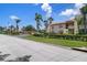 Landscaped street with lush greenery and well-maintained townhome exterior at 2571 Cyprus Dr # 1-202, Palm Harbor, FL 34684