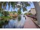 Scenic waterfront view with lush greenery, dock access, and charming houses creating a serene and picturesque neighborhood at 2571 Cyprus Dr # 1-202, Palm Harbor, FL 34684