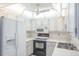 White kitchen with built-in microwave and ceiling fan at 2740 Whitebridge Dr # A, Palm Harbor, FL 34684