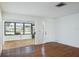 Living room with wood floors and sliding glass doors to the sunroom at 2740 Whitebridge Dr # A, Palm Harbor, FL 34684