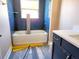 Bathroom featuring a new vanity with navy blue cabinets, subway tile and new flooring at 417 Shannon Estates Ct, Plant City, FL 33563