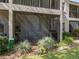 Ground level view of the screened porch and landscaping at 9700 Starkey Rd # 312, Seminole, FL 33777