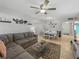 Open living and dining area with gray sectional sofa and white dining set at 9700 Starkey Rd # 312, Seminole, FL 33777