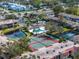 Aerial view of community with pool, tennis courts, and lush landscaping at 9700 Starkey Rd # 312, Seminole, FL 33777