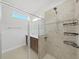 Walk-in shower with tile surround and shelving at 11633 Mandevilla View Way, Riverview, FL 33579