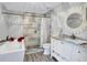 Spa-like bathroom with a soaking tub, walk-in shower, and updated vanity at 516 S Crest Ave, Clearwater, FL 33756