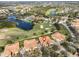 Aerial view of community, showing homes, golf course, and lake at 1357 Emerald Dunes Dr, Sun City Center, FL 33573
