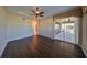 Bedroom with dark wood floors and access to a patio at 1357 Emerald Dunes Dr, Sun City Center, FL 33573