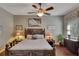 Bedroom with ceiling fan, wood flooring, and a dresser at 1357 Emerald Dunes Dr, Sun City Center, FL 33573
