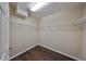 Spacious walk-in closet with wire shelving and wood flooring at 1357 Emerald Dunes Dr, Sun City Center, FL 33573