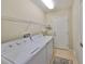 Bright laundry room with washer, dryer, and ample shelving at 1357 Emerald Dunes Dr, Sun City Center, FL 33573