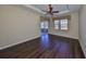 Spacious bedroom with dark wood floors and sliding doors at 1357 Emerald Dunes Dr, Sun City Center, FL 33573