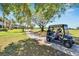 Person driving golf cart on path beside homes and golf course at 1357 Emerald Dunes Dr, Sun City Center, FL 33573