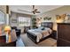 Large main bedroom with dark wood floors and ceiling fan at 1357 Emerald Dunes Dr, Sun City Center, FL 33573