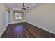 Bright bedroom with dark wood floors and large window at 1357 Emerald Dunes Dr, Sun City Center, FL 33573