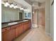 Bathroom boasts double sinks, wood cabinets, and a large shower at 1357 Emerald Dunes Dr, Sun City Center, FL 33573