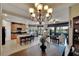 Kitchen and living area with wood dining table and chandelier at 1357 Emerald Dunes Dr, Sun City Center, FL 33573