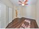 Bedroom with ceiling fan, wood flooring, and access to bathroom at 1357 Emerald Dunes Dr, Sun City Center, FL 33573