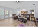 Open-concept living room with wood floors and access to the kitchen and patio at 1467 Monte St, Port Charlotte, FL 33952